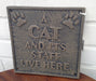 Cast Iron Cat Sign - A CAT AND IT'S STAFF LIVE HERE